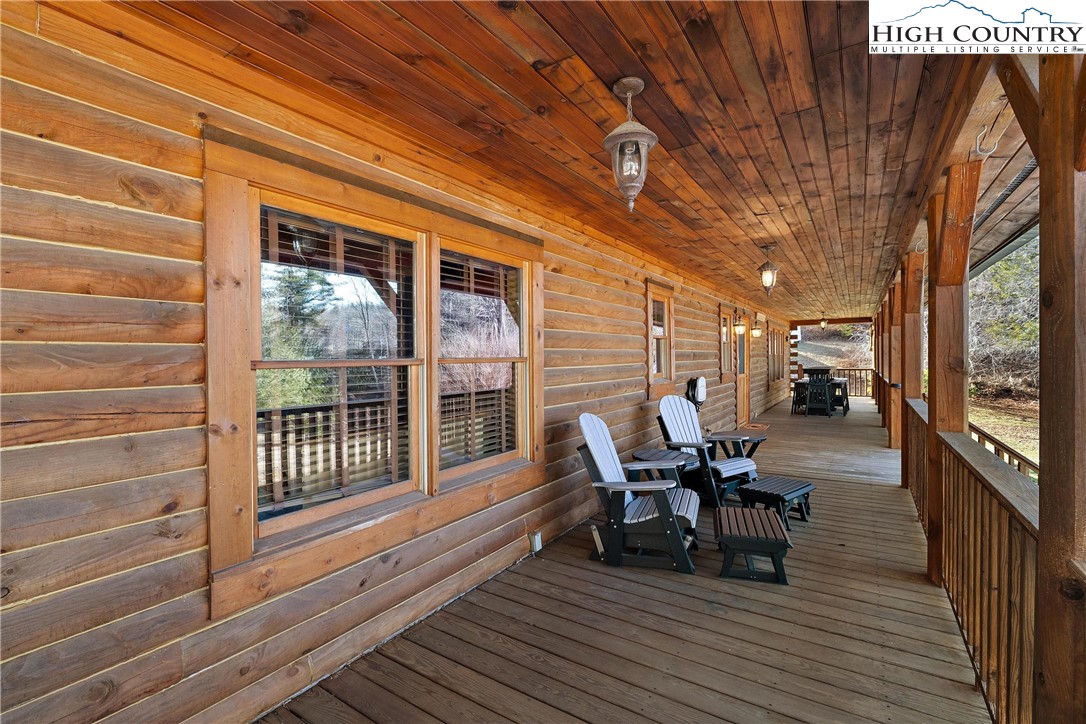 52 Hackett Gragg Road Newland, NC 28657 - Photo 8 of 41 a view of a patio with table and chairs and wooden floor
