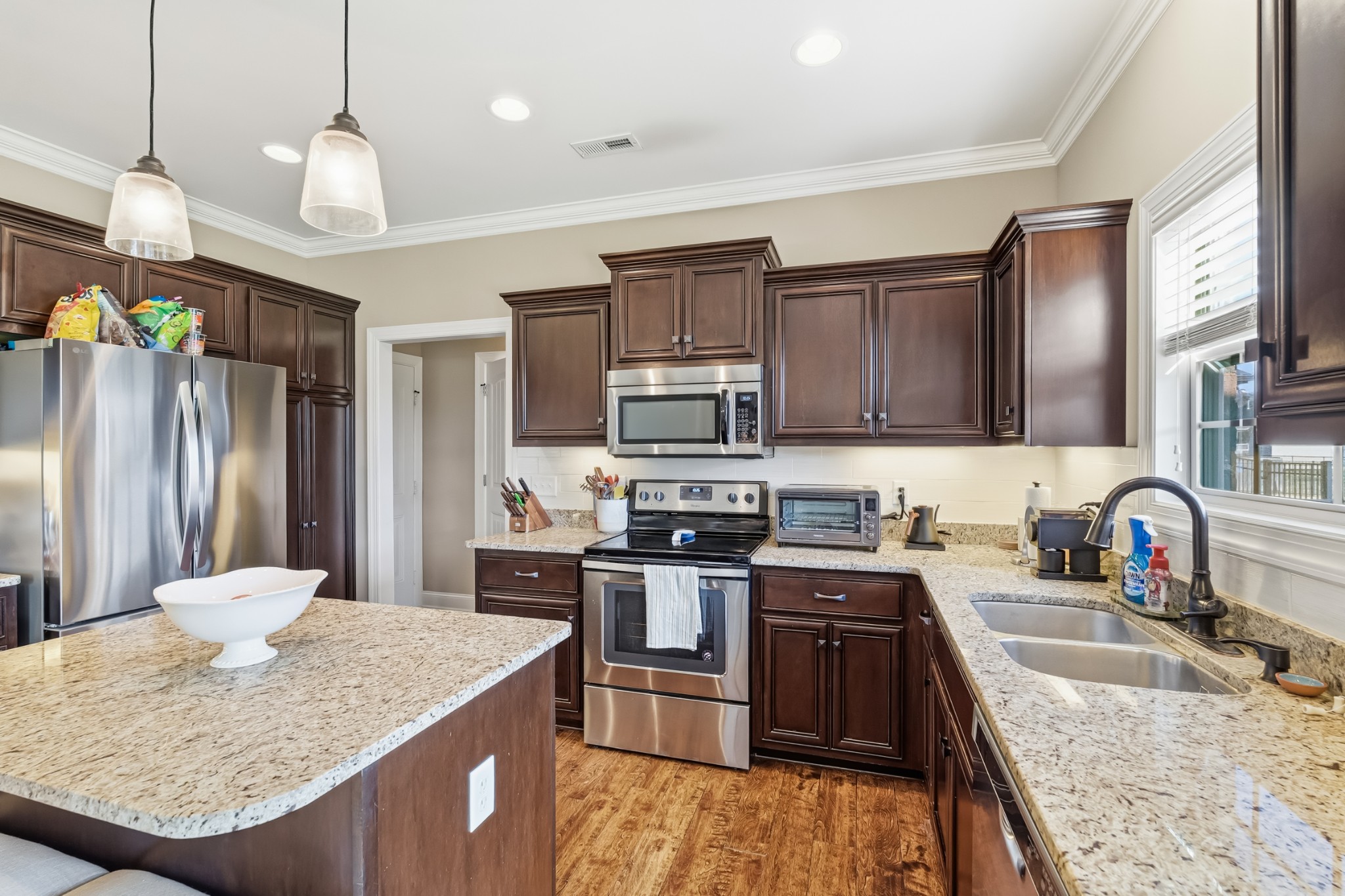 1008 Ash Ridge Road Lascassas, TN 37085 - Photo 10 of 34 a kitchen with stainless steel appliances granite countertop a sink refrigerator and cabinets