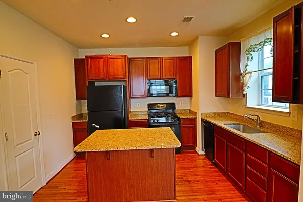 a kitchen with a sink stove and refrigerator