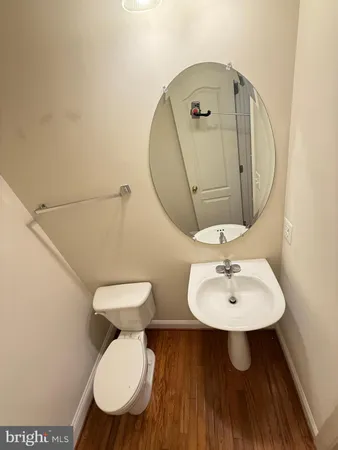 a bathroom with a toilet a sink and mirror