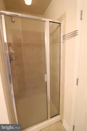 a bathroom with a glass shower door