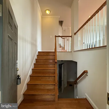 a view of entryway and hall with wooden floor