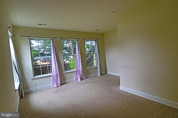 a view of an empty room with a balcony
