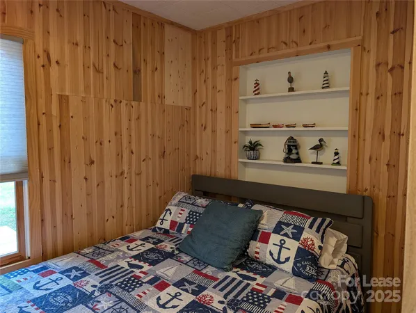 a room with a bed and cabinets
