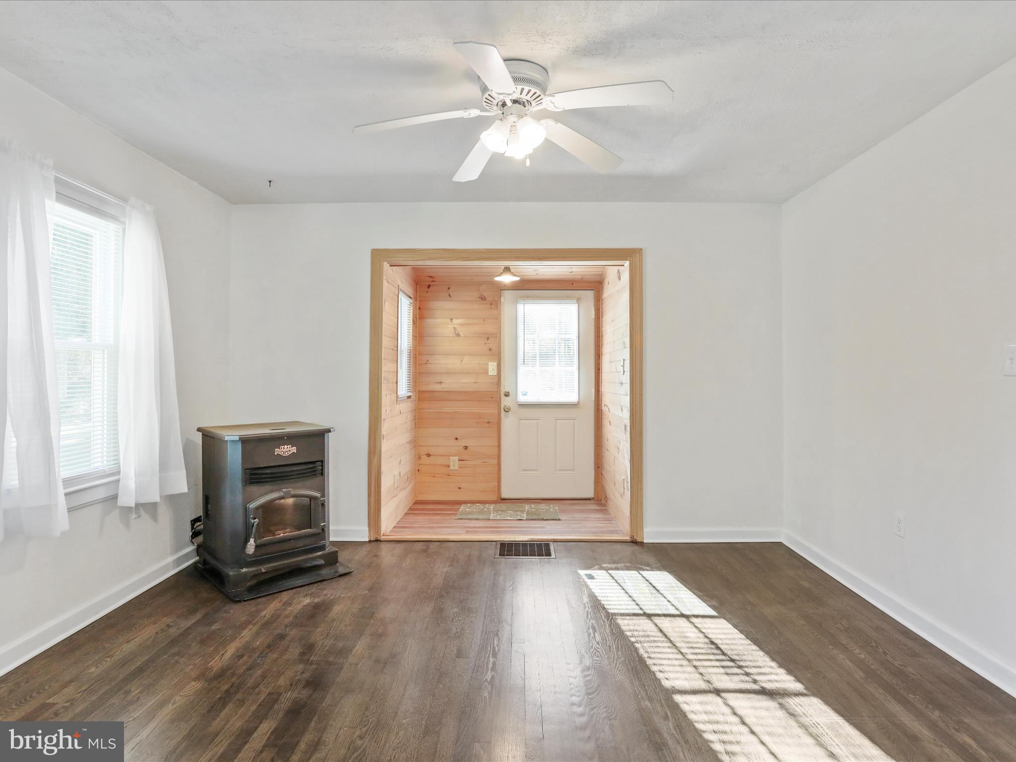 25411 Cascade Road Cascade, MD 21719 - Photo 11 of 53 an empty room with windows and fireplace