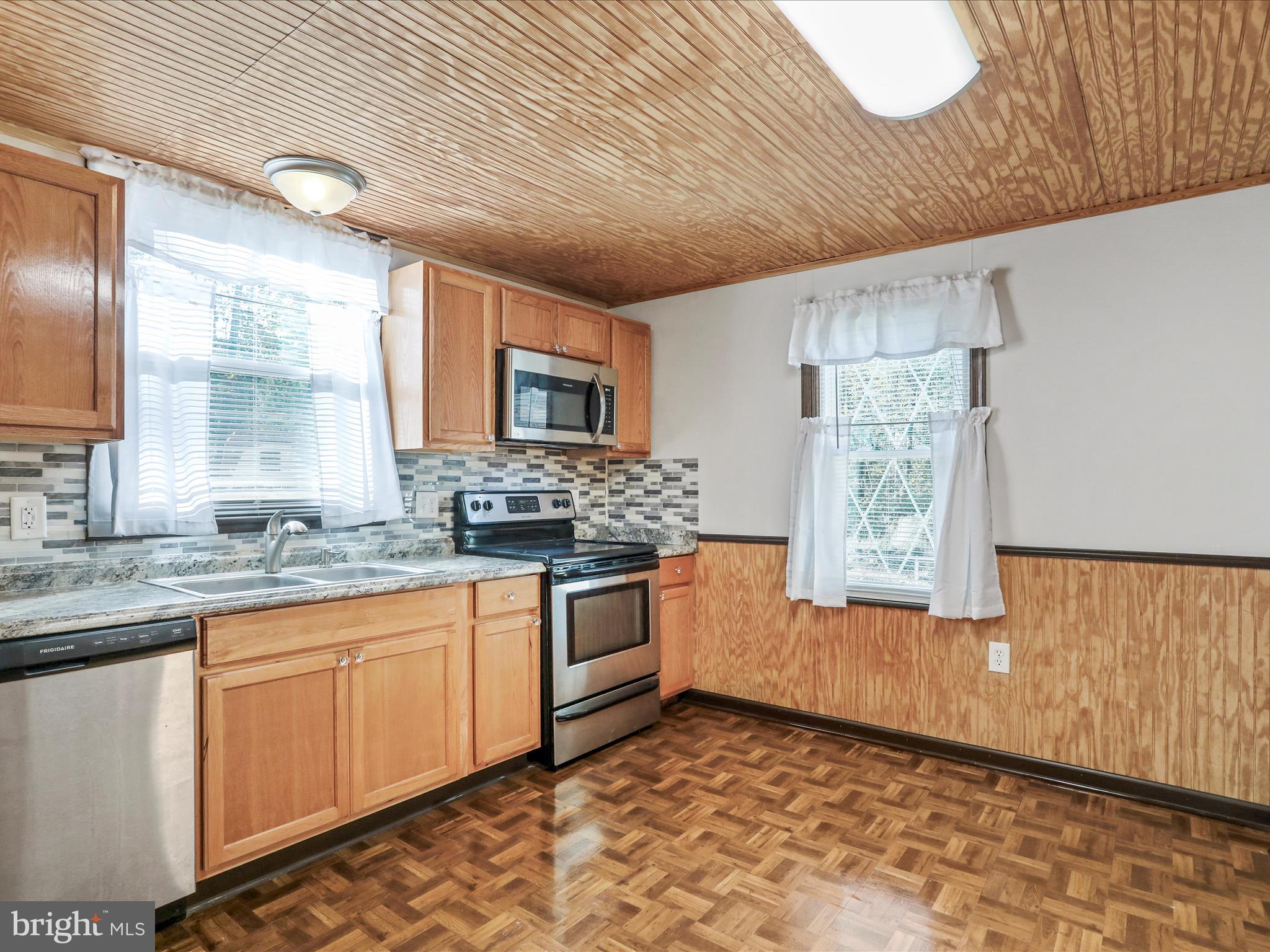 25411 Cascade Road Cascade, MD 21719 - Photo 15 of 53 a large kitchen with granite countertop a sink window and cabinets