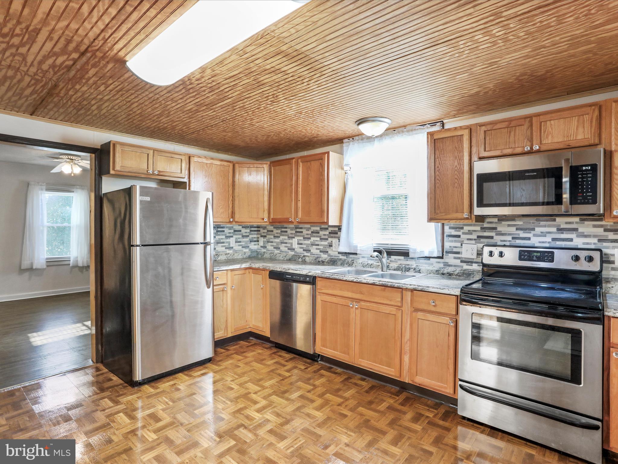 25411 Cascade Road Cascade, MD 21719 - Photo 18 of 53 a kitchen with stainless steel appliances granite countertop a refrigerator a stove a sink and a microwave