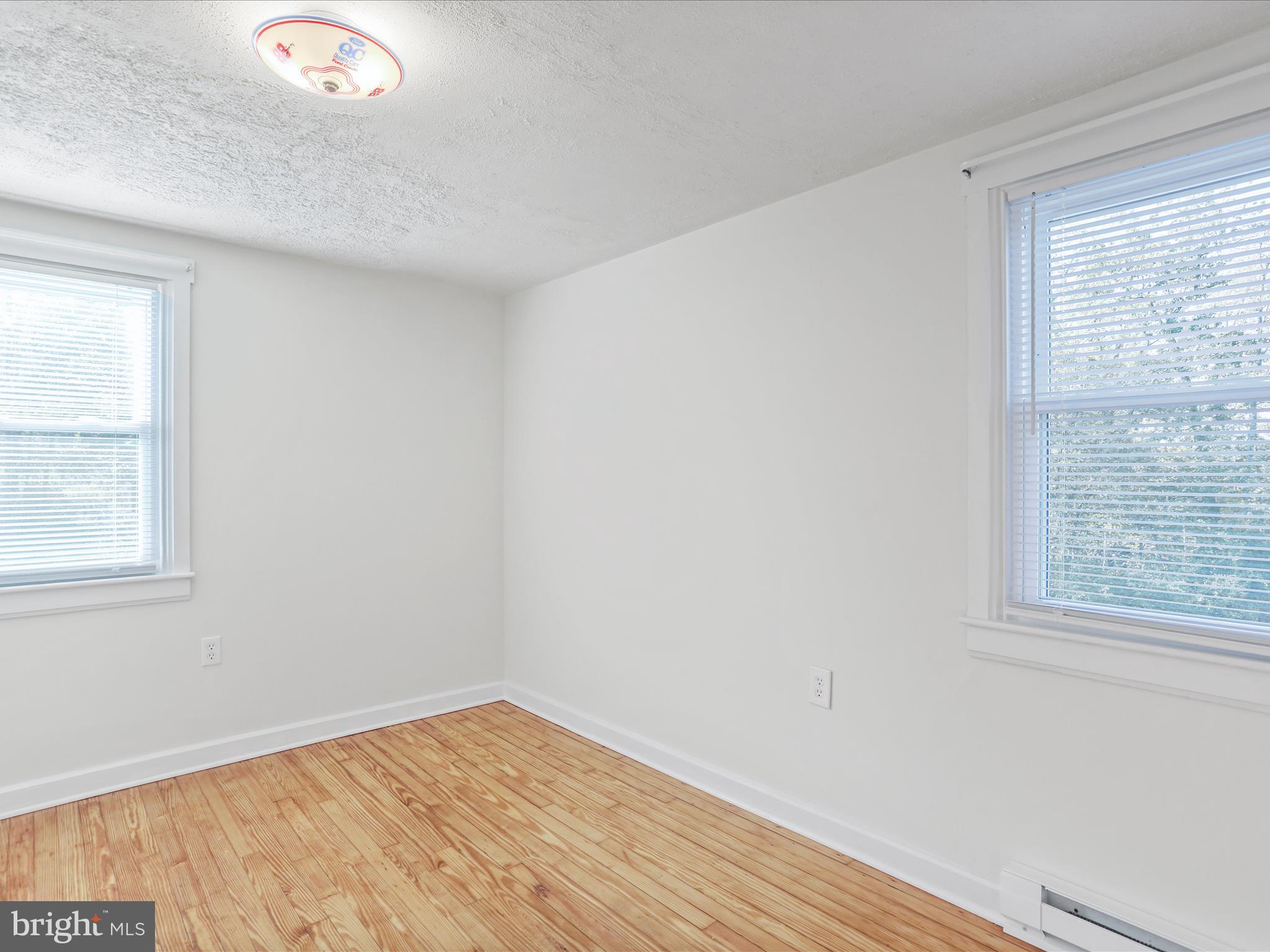 25411 Cascade Road Cascade, MD 21719 - Photo 26 of 53 an empty room with wooden floor and windows