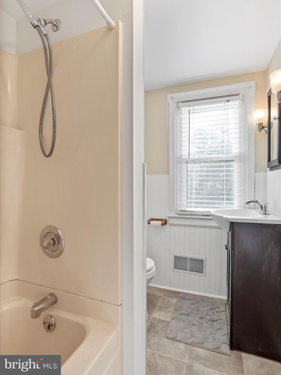 25411 Cascade Road Cascade, MD 21719 - Photo 28 of 53 a bathroom with a tub a sink a window and a shower