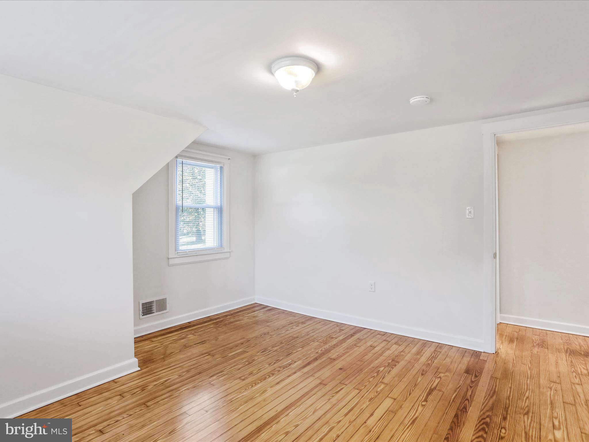 25411 Cascade Road Cascade, MD 21719 - Photo 32 of 53 an empty room with wooden floor and windows