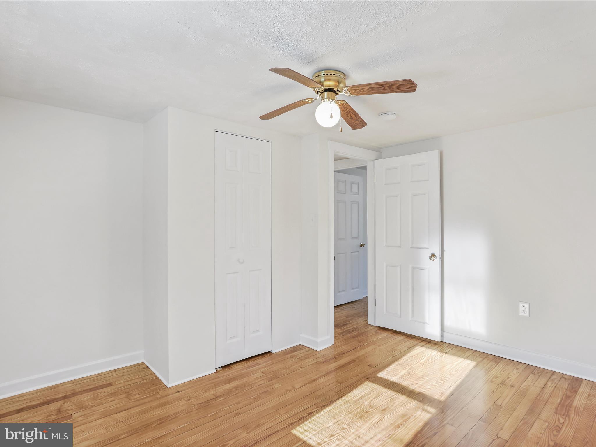 25411 Cascade Road Cascade, MD 21719 - Photo 34 of 53 a view of a room with wooden floor and ceiling fan
