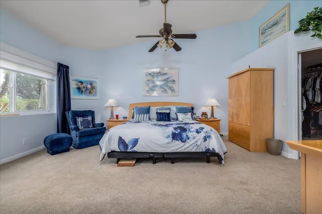 a spacious bedroom with a bed a couch and a window