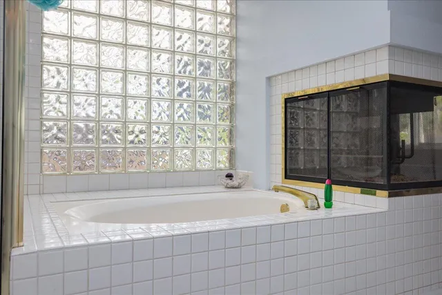 a bath tub sitting in a bathroom next to a window