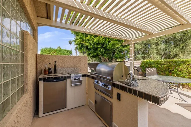 a view of a patio with table and chairs and potted plants