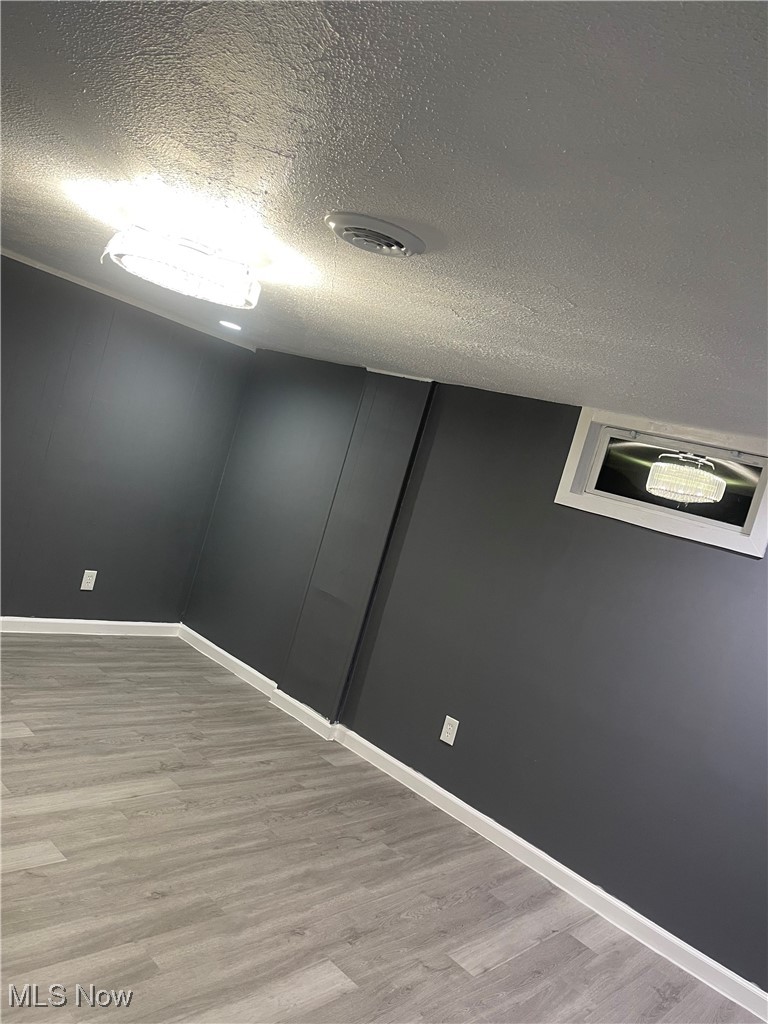 603 Liberty Road Youngstown, OH 44505 - Photo 24 of 42 Below grade area featuring a textured ceiling and light wood-type flooring