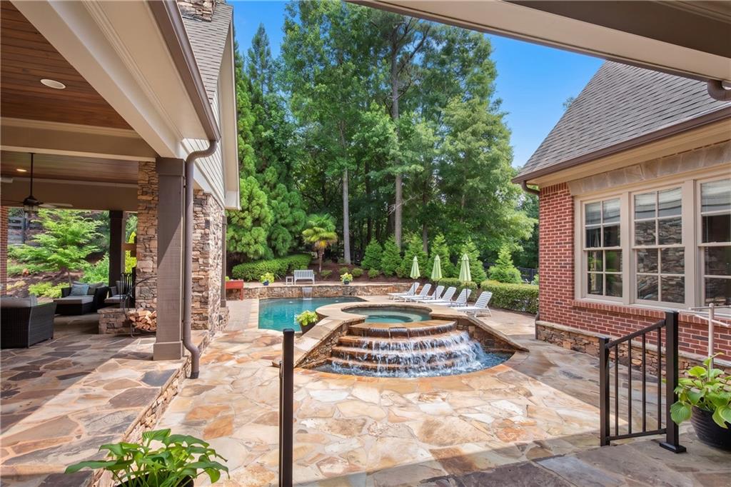 13942 Tree Loft Road Milton, GA 30004 - Photo 80 of 102 a view of a patio with table and chairs potted plants and floor to ceiling window