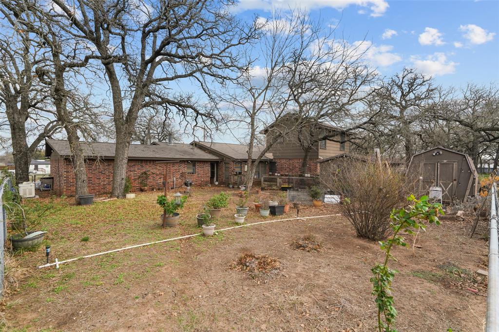 1051 Lynch Bend Road Springtown, TX 76082 - Photo 35 of 39 a view of a yard with a tree in front of house