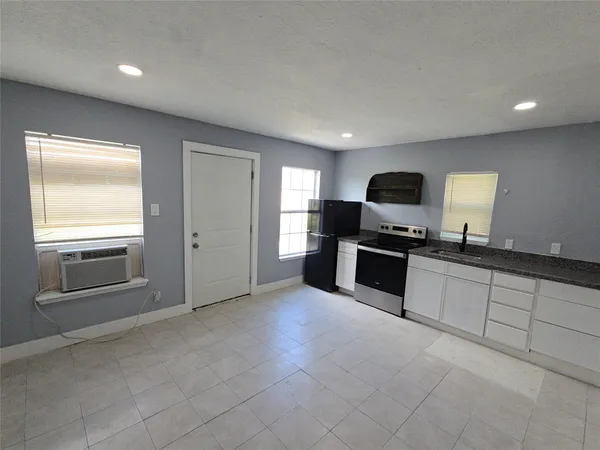 a large kitchen with cabinets and stainless steel appliances