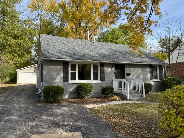 a front view of a house with garden and porch