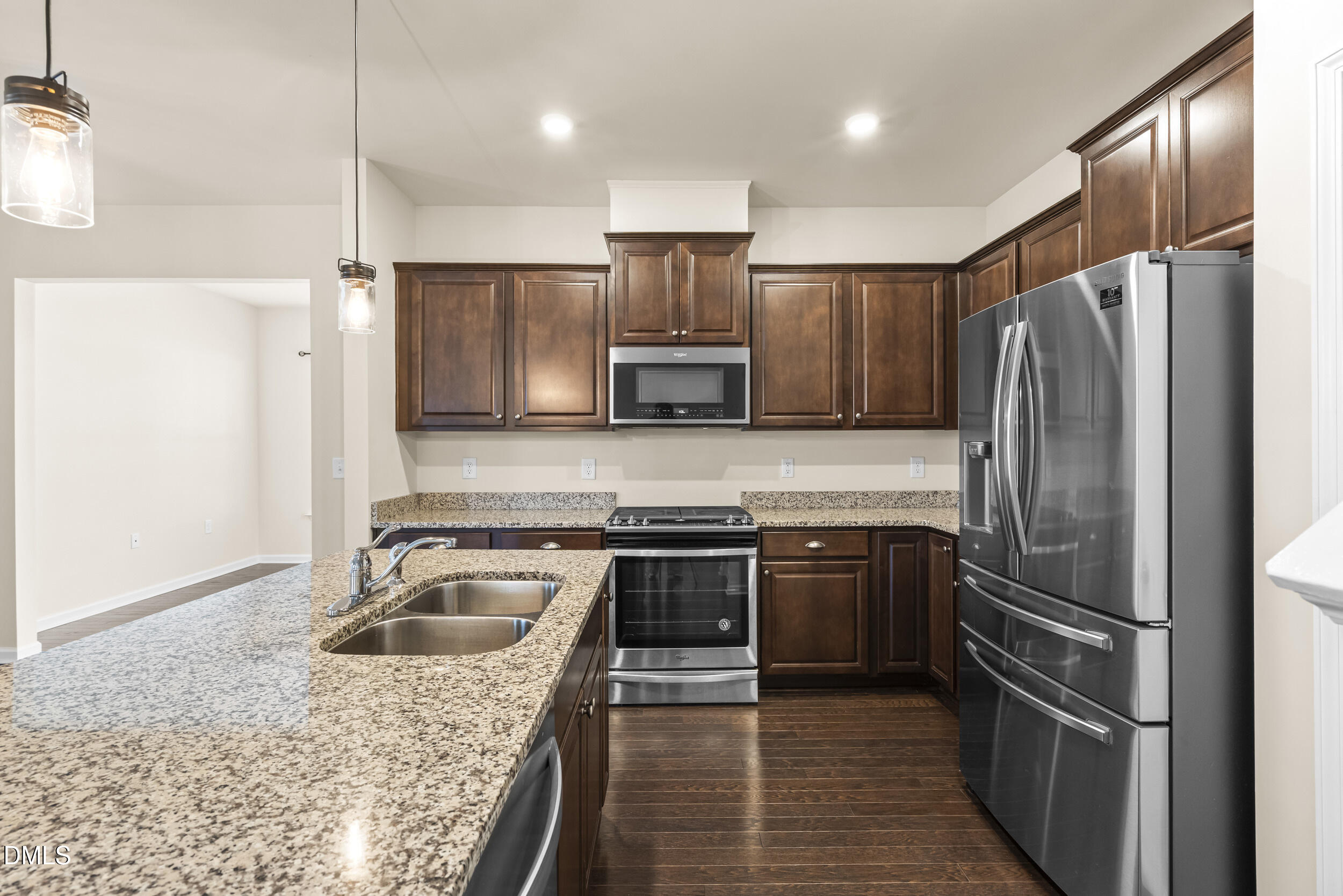 113 Lafferty Street Durham, NC 27703 - Photo 12 of 39 a kitchen with kitchen island stainless steel appliances granite countertop a sink stove and refrigerator
