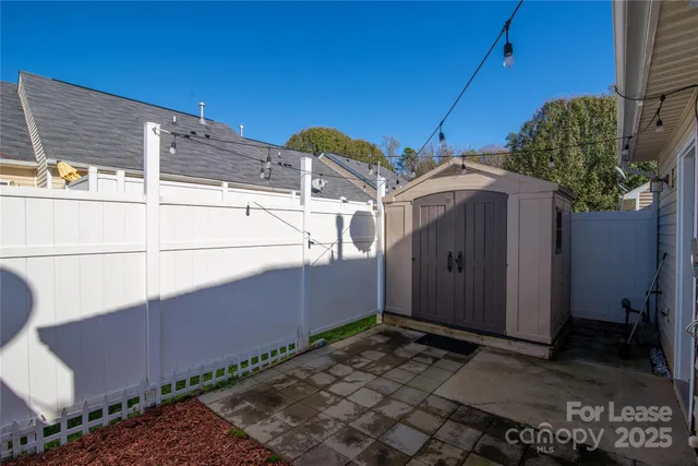 a view of a street with wooden fence