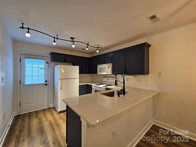 a kitchen with a sink a stove and cabinets