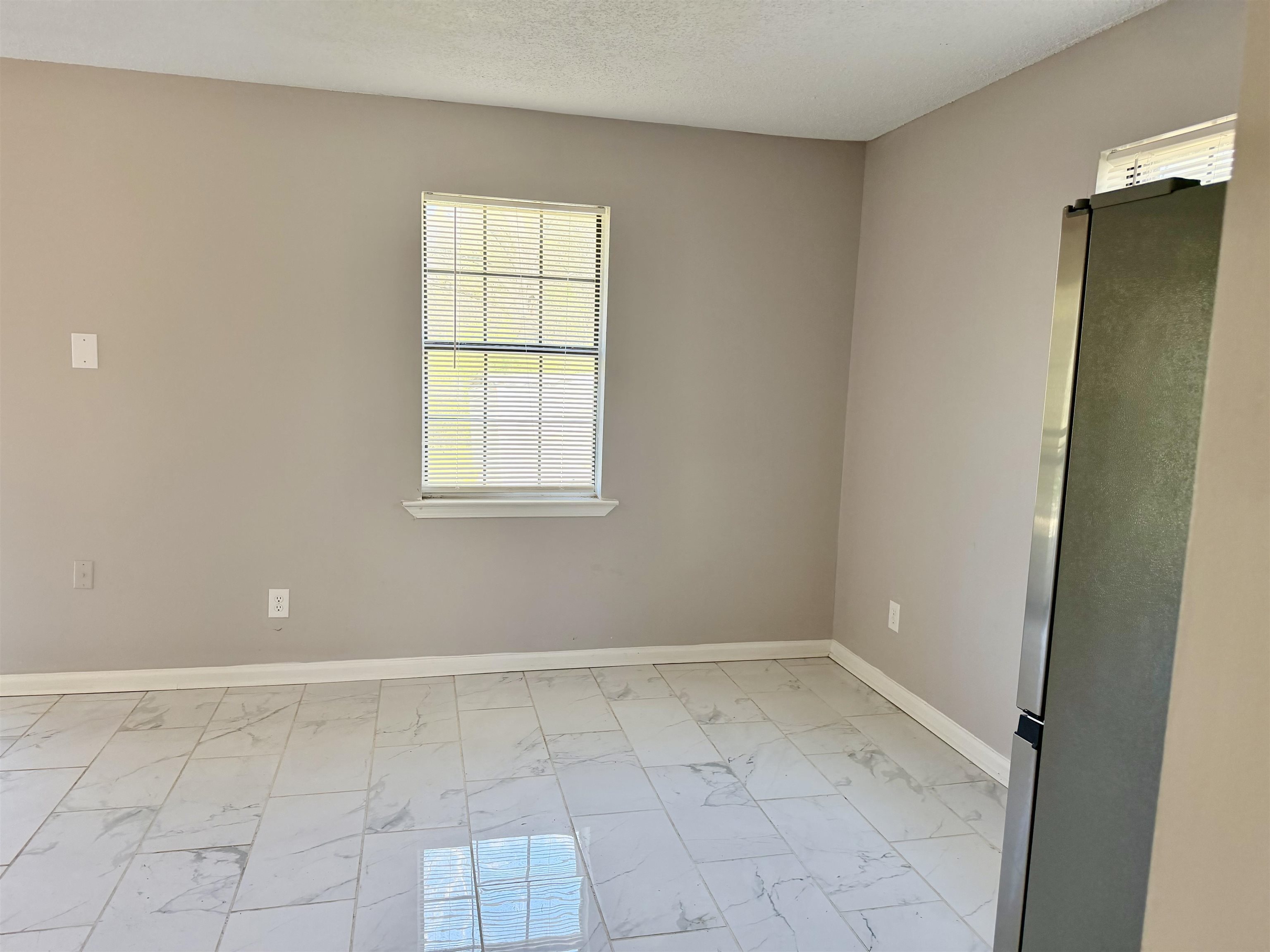 2215 Henrietta Road Memphis, TN 38134 - Photo 5 of 10 Unfurnished room with light marble finish floors and a textured ceiling