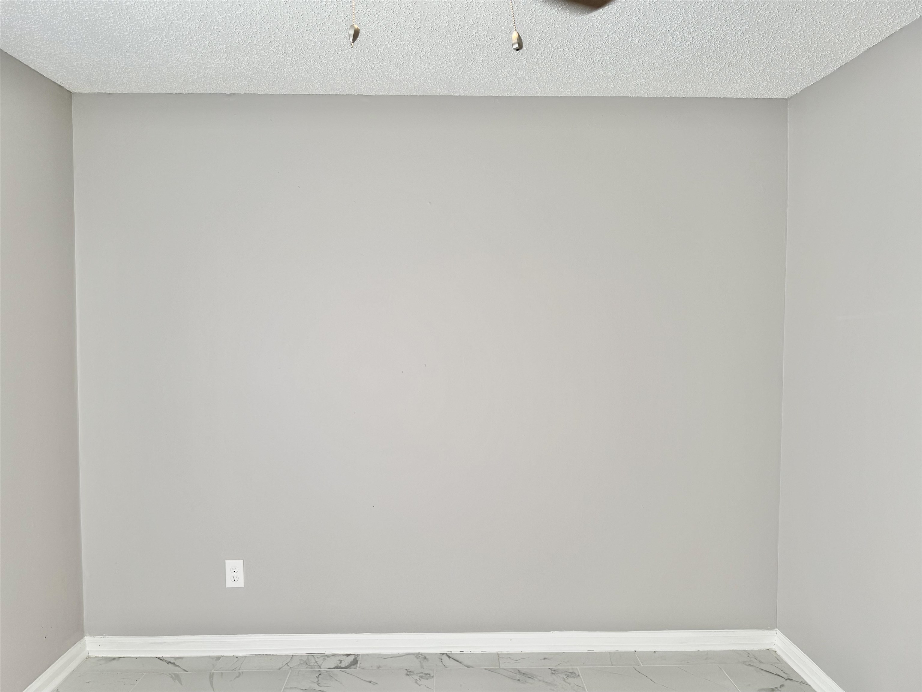 2215 Henrietta Road Memphis, TN 38134 - Photo 6 of 10 Empty room with light marble finish floors and a textured ceiling
