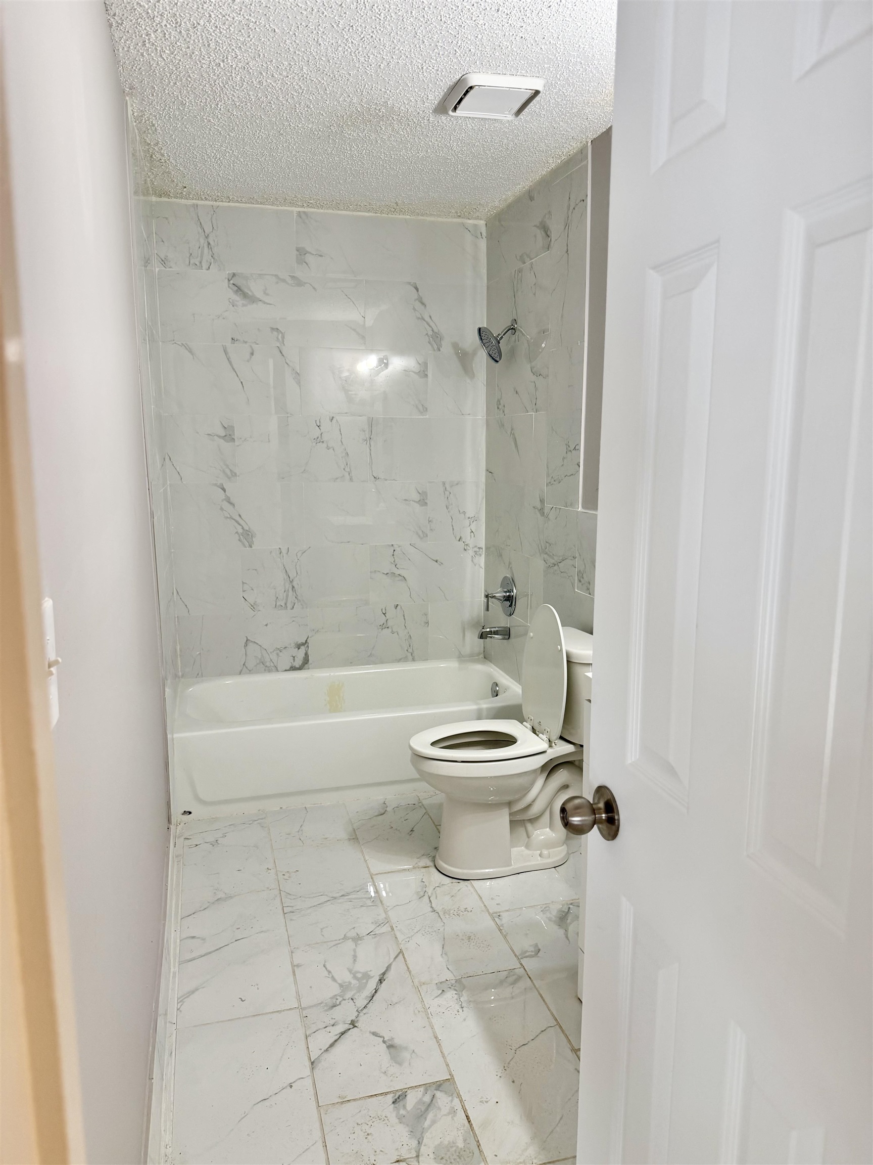 2215 Henrietta Road Memphis, TN 38134 - Photo 10 of 10 Bathroom with light marble finish floors, tub / shower combination, and a textured ceiling