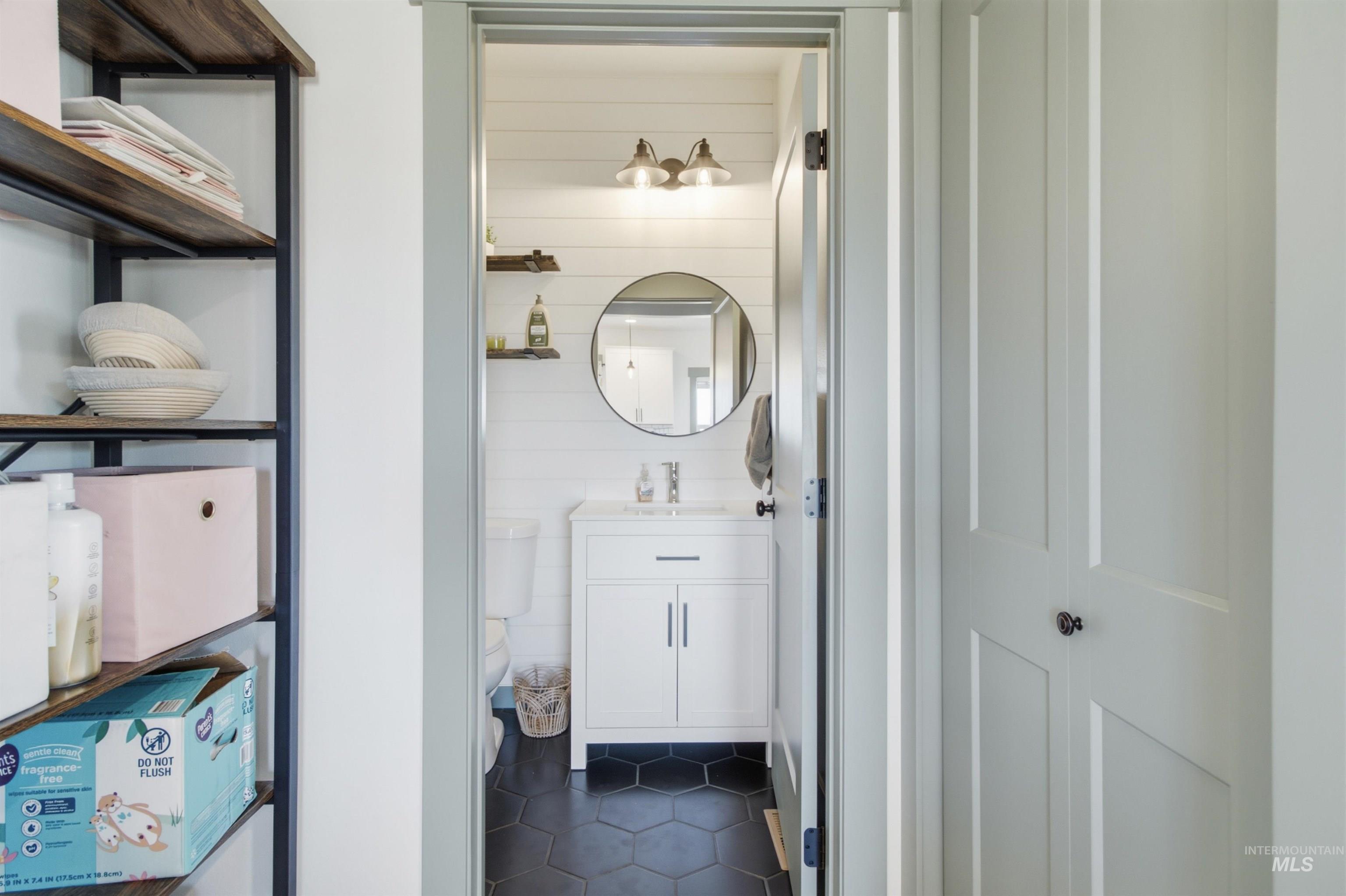 1032 Duffield Flat Road Potlatch, ID 83855 - Photo 36 of 50 Powder room with hexagon floor tiling, shiplap wall paneling, and a single-sink vanity