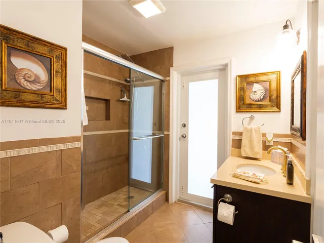 a bathroom with a sink a mirror and a shower