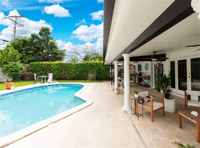 a view of a patio with swimming pool table and chairs