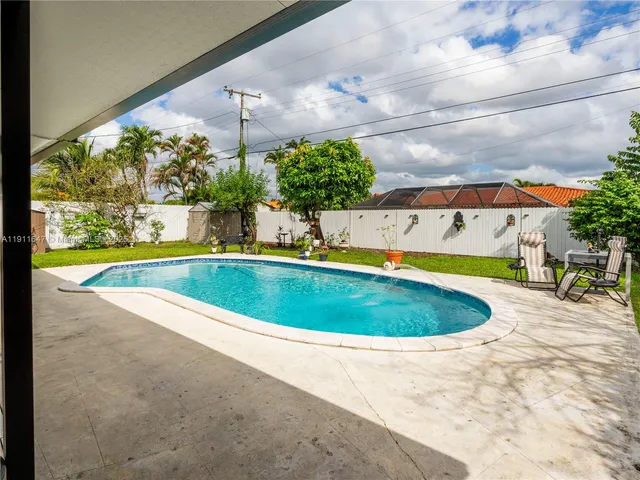a view of a swimming pool with a yard