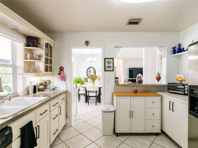 a kitchen with appliances cabinets and furniture