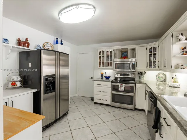 a kitchen with stainless steel appliances a refrigerator sink and stove