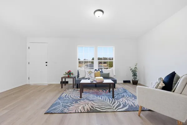 a living room with furniture rug and window