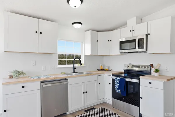a kitchen with a sink stove and white cabinets