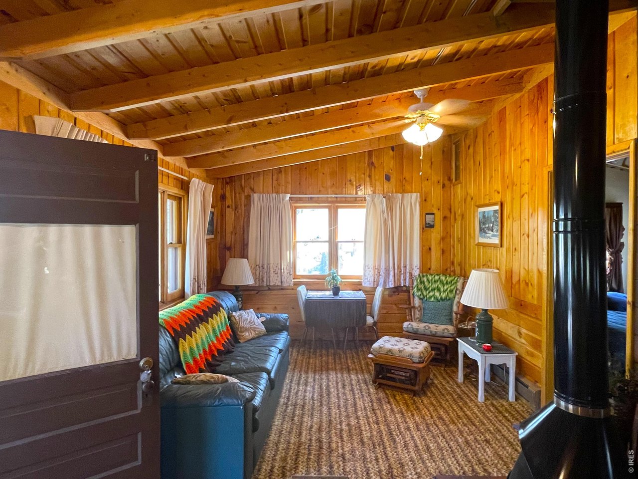 35 Robin Path Red Feather Lakes, CO 80545 - Photo 6 of 25 Warm wood walls in the living area.