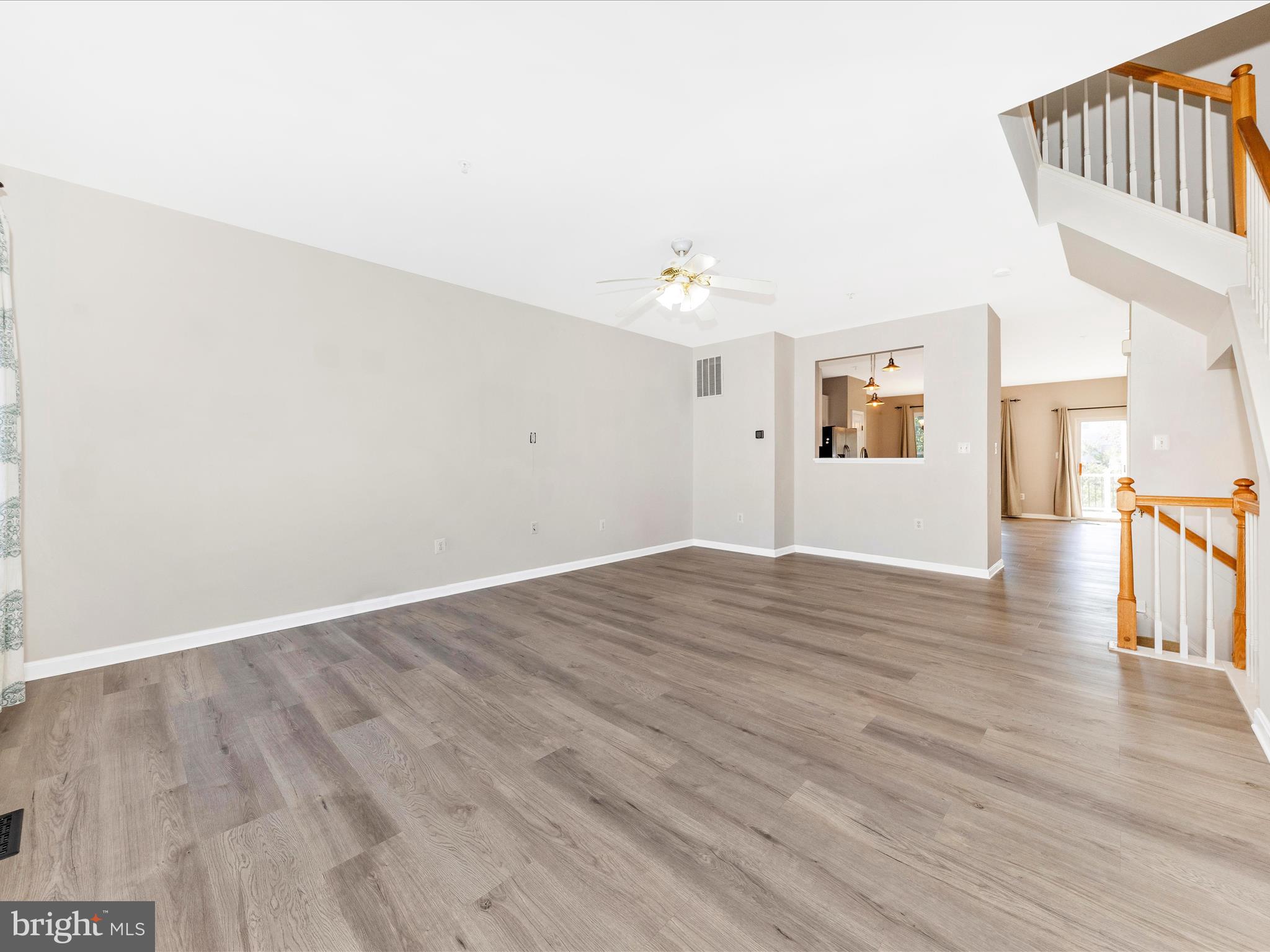 2103 Paxton Terrace Frederick, MD 21702 - Photo 12 of 51 a view of an empty room with wooden floor and a window