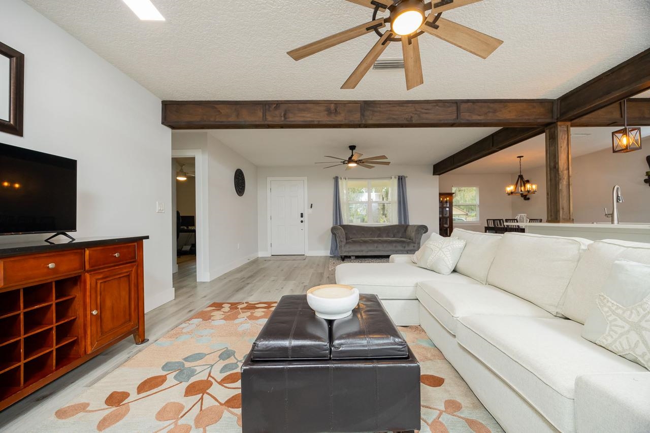 110 Queen Road St. Augustine, FL 32086 - Photo 13 of 37 a living room with furniture and a flat screen tv