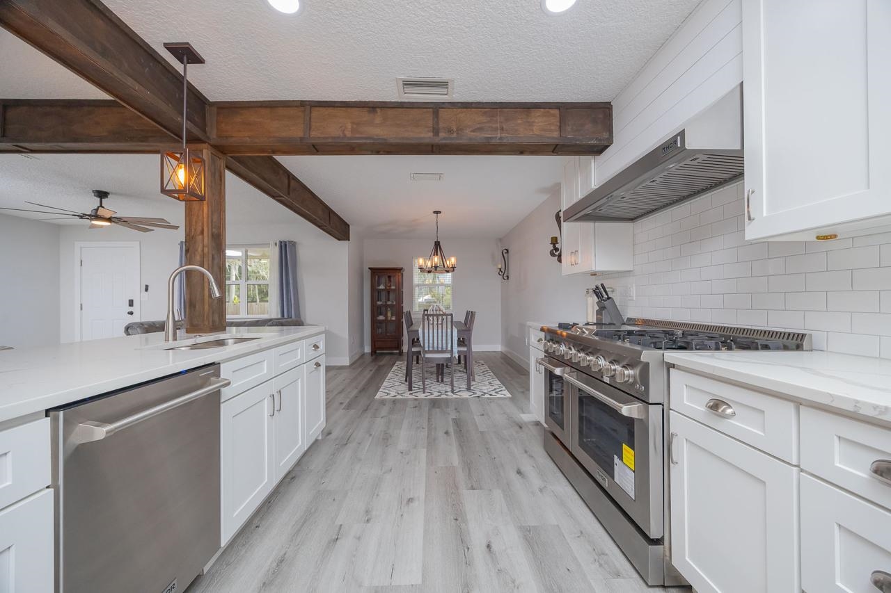 110 Queen Road St. Augustine, FL 32086 - Photo 17 of 37 a kitchen with stove a sink and refrigerator