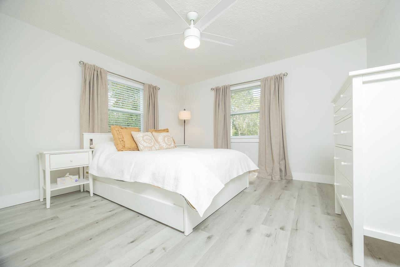 110 Queen Road St. Augustine, FL 32086 - Photo 30 of 37 a bedroom with a bed and a chandelier