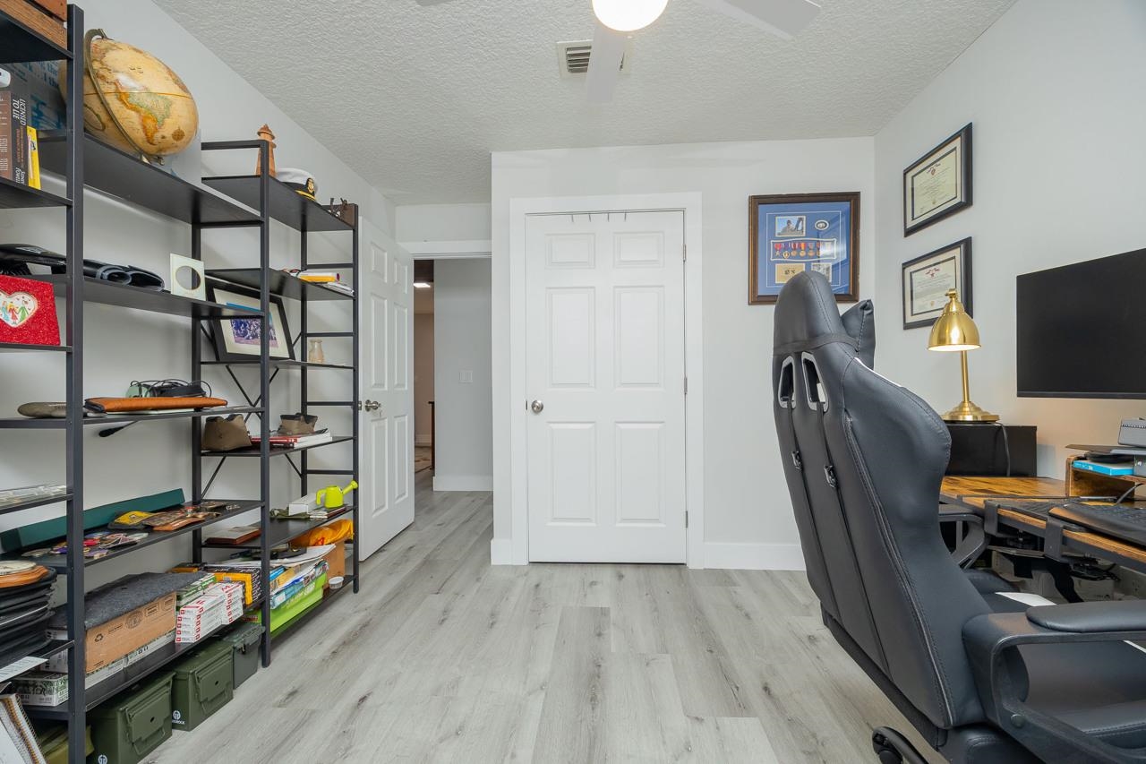 110 Queen Road St. Augustine, FL 32086 - Photo 36 of 37 a view of a workspace with furniture and flat screen tv