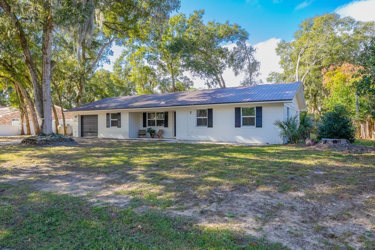 110 Queen Road St. Augustine, FL 32086 - Photo 5 of 37 a view of a house with backyard and trees