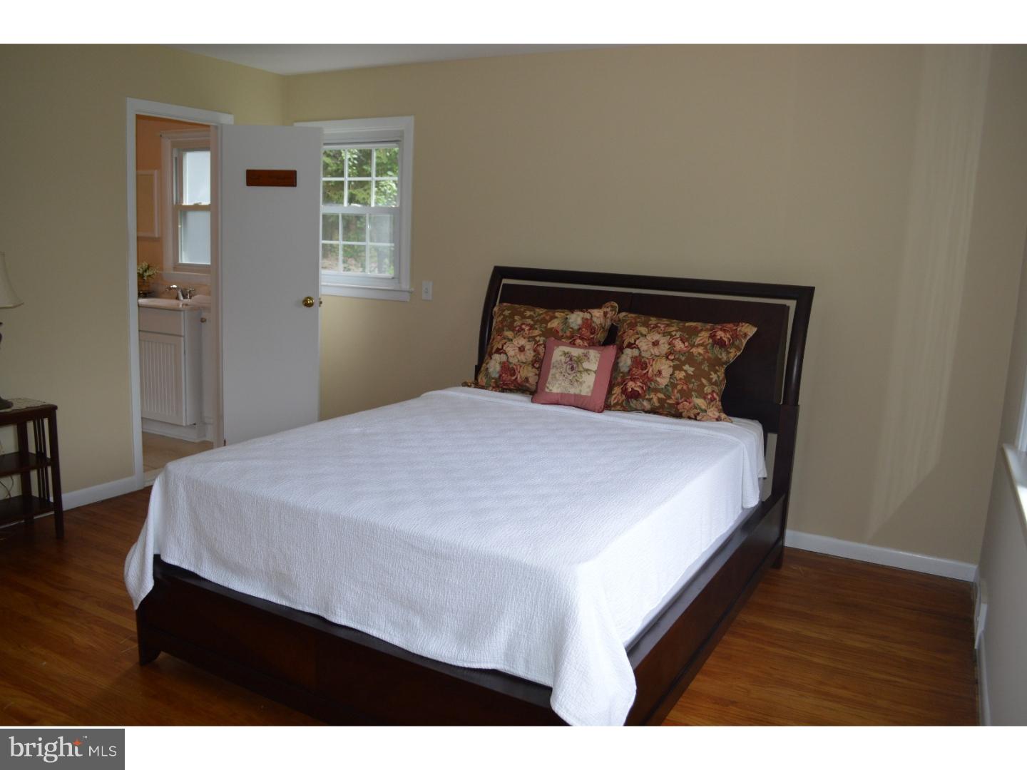 722 Berwyn Baptist Road Devon, PA 19333 - Photo 14 of 24 a bedroom with a bed and wooden floor