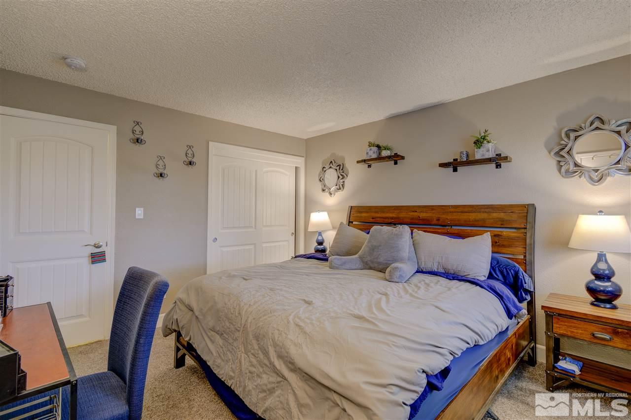 1408 East 9th Street Reno, NV 89512 - Photo 12 of 25 a bedroom with a bed and wooden floor