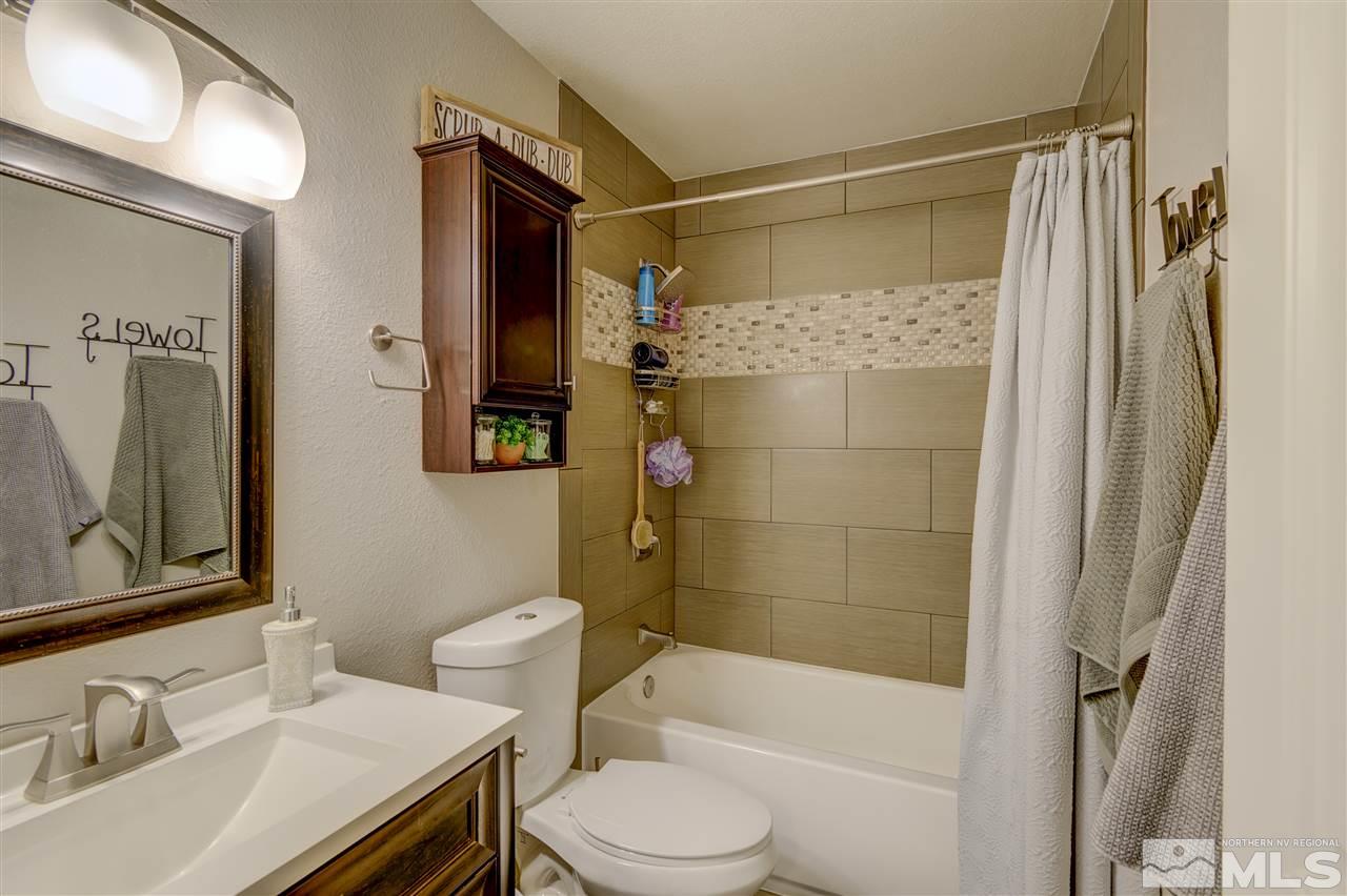 1408 East 9th Street Reno, NV 89512 - Photo 15 of 25 a bathroom with a sink toilet and shower
