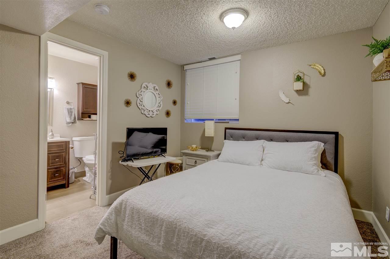 1408 East 9th Street Reno, NV 89512 - Photo 20 of 25 a bed room with a bed and a chair