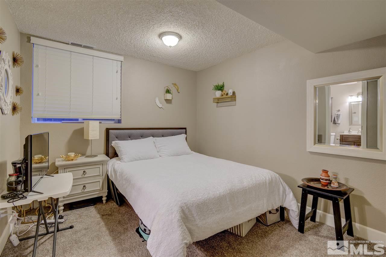 1408 East 9th Street Reno, NV 89512 - Photo 21 of 25 a bedroom with a bed a table and chair