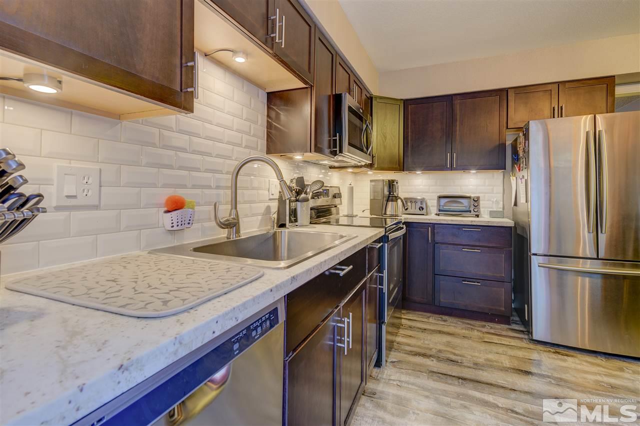 1408 East 9th Street Reno, NV 89512 - Photo 3 of 25 a kitchen with stainless steel appliances granite countertop a sink stove and refrigerator